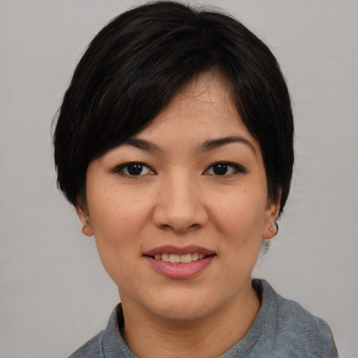 Joyful asian young-adult female with medium  black hair and brown eyes
