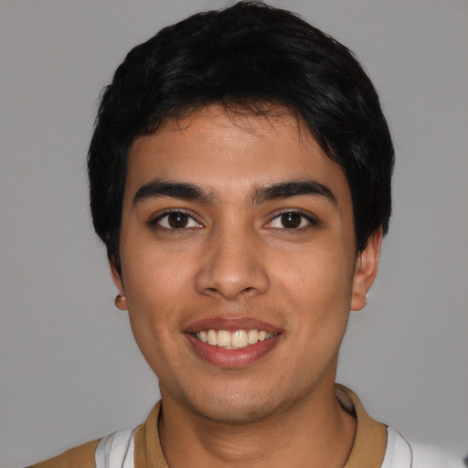 Joyful latino young-adult male with short  black hair and brown eyes