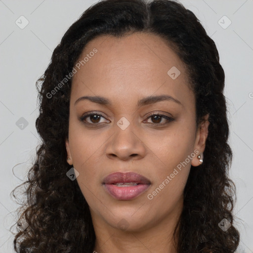 Joyful black young-adult female with long  brown hair and brown eyes