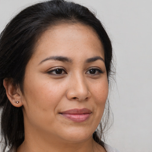 Joyful latino young-adult female with long  brown hair and brown eyes