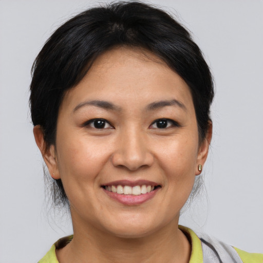 Joyful asian young-adult female with medium  brown hair and brown eyes