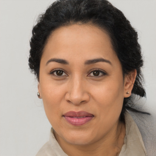 Joyful latino adult female with short  brown hair and brown eyes