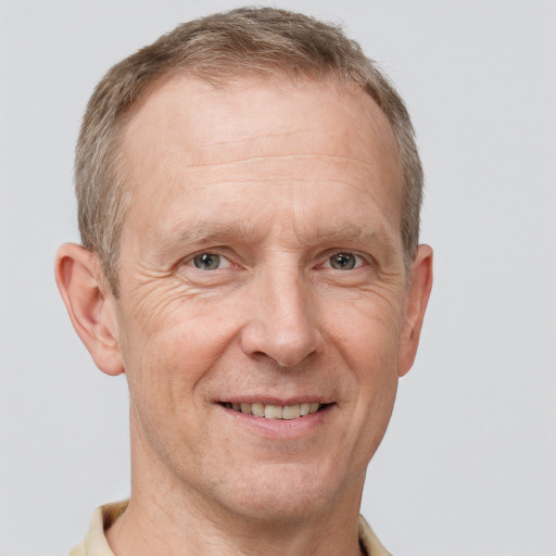 Joyful white middle-aged male with short  brown hair and grey eyes