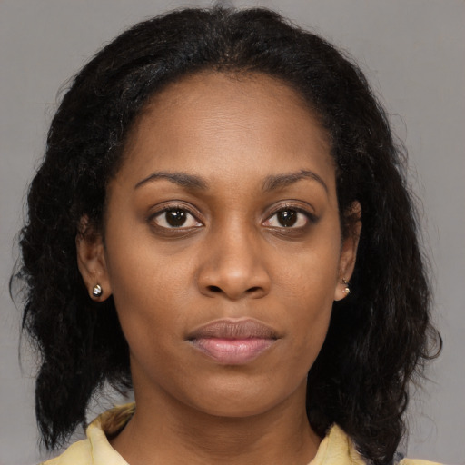 Neutral black young-adult female with long  brown hair and brown eyes