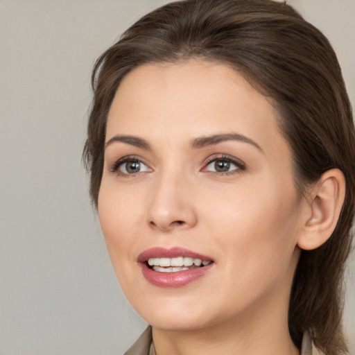 Joyful white young-adult female with medium  brown hair and brown eyes