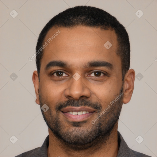 Joyful latino young-adult male with short  black hair and brown eyes