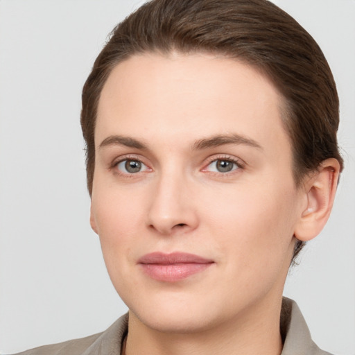 Joyful white young-adult female with short  brown hair and grey eyes