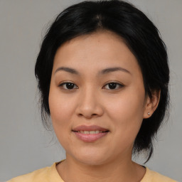 Joyful asian young-adult female with medium  black hair and brown eyes