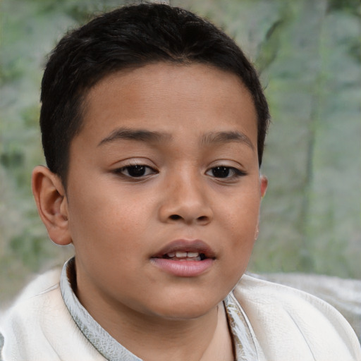 Joyful latino child male with short  brown hair and brown eyes