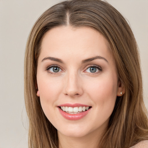 Joyful white young-adult female with long  brown hair and green eyes