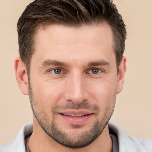 Joyful white young-adult male with short  brown hair and brown eyes