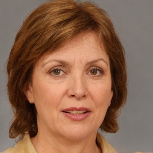 Joyful white adult female with medium  brown hair and blue eyes