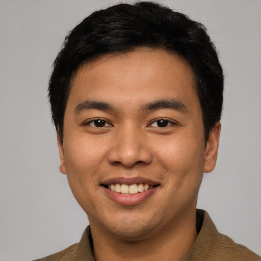 Joyful asian young-adult male with short  black hair and brown eyes
