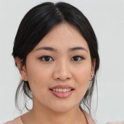 Joyful asian young-adult female with medium  black hair and brown eyes