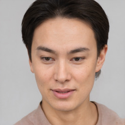 Joyful asian young-adult male with short  brown hair and brown eyes