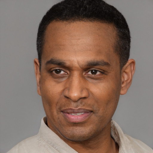 Joyful latino adult male with short  black hair and brown eyes