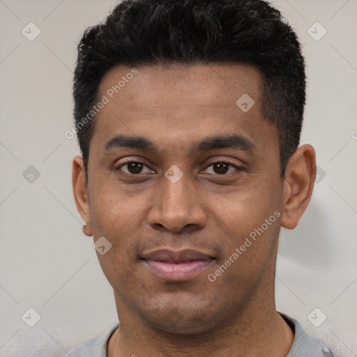 Joyful latino young-adult male with short  black hair and brown eyes