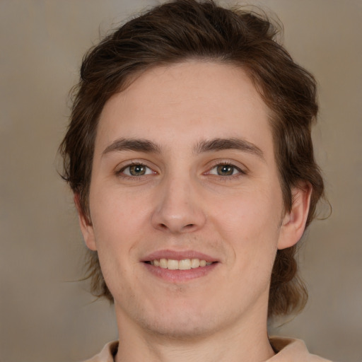 Joyful white young-adult male with medium  brown hair and brown eyes