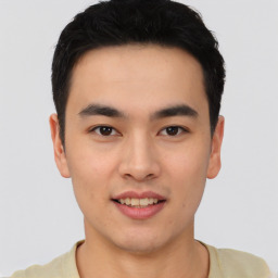 Joyful asian young-adult male with short  black hair and brown eyes