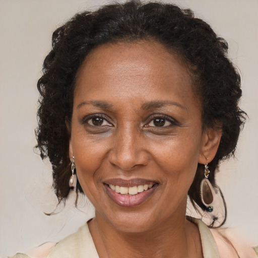 Joyful black adult female with medium  brown hair and brown eyes