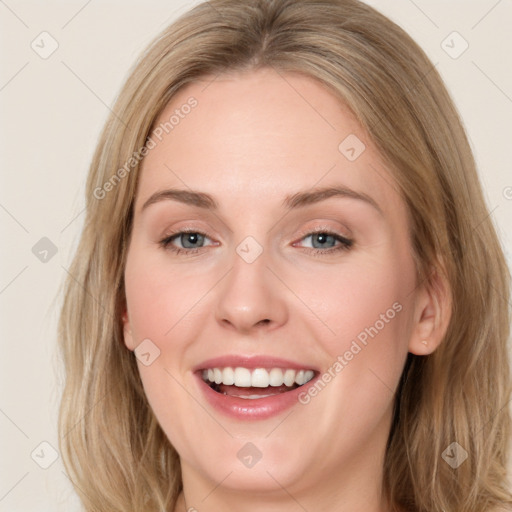 Joyful white young-adult female with long  brown hair and blue eyes