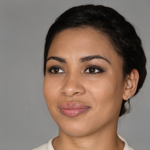 Joyful latino young-adult female with short  black hair and brown eyes