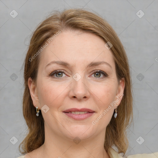 Joyful white adult female with medium  brown hair and grey eyes