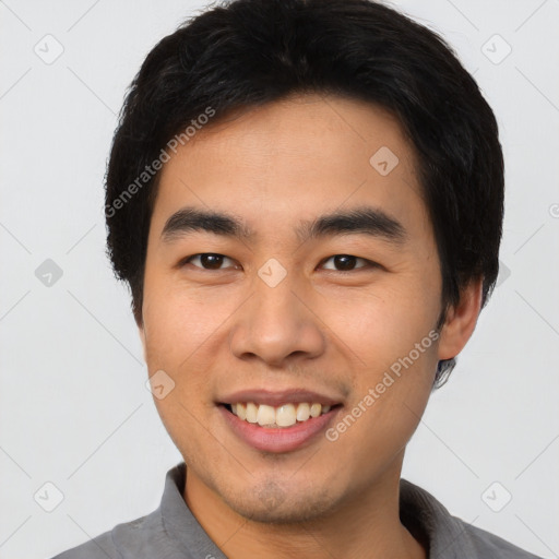 Joyful asian young-adult male with short  black hair and brown eyes