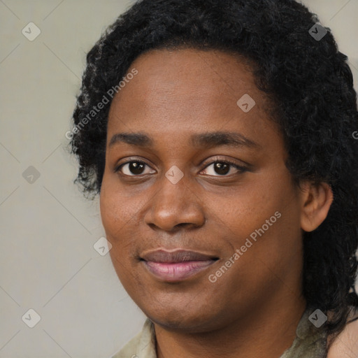 Joyful black young-adult female with long  black hair and brown eyes