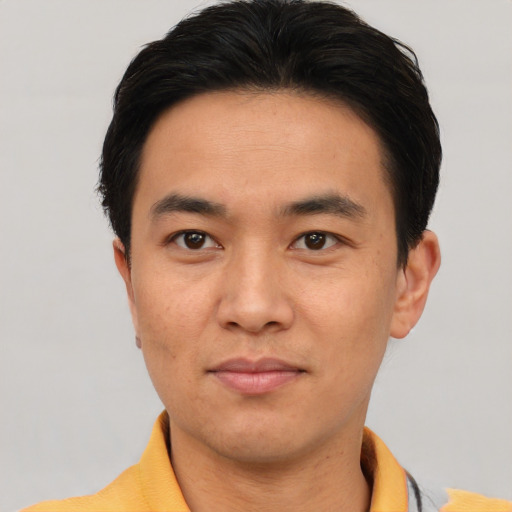 Joyful asian young-adult male with short  black hair and brown eyes