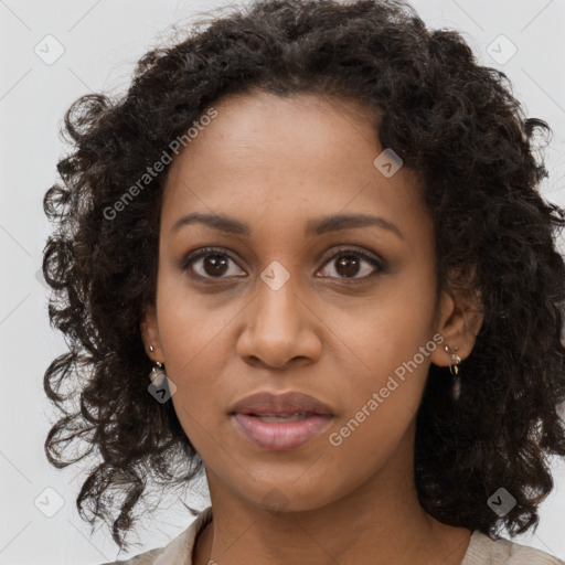 Joyful black young-adult female with long  brown hair and brown eyes