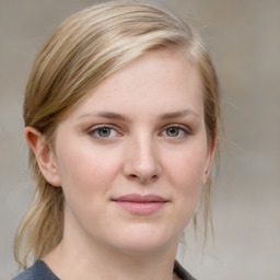 Joyful white young-adult female with medium  brown hair and blue eyes