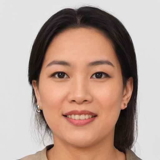 Joyful asian young-adult female with medium  black hair and brown eyes