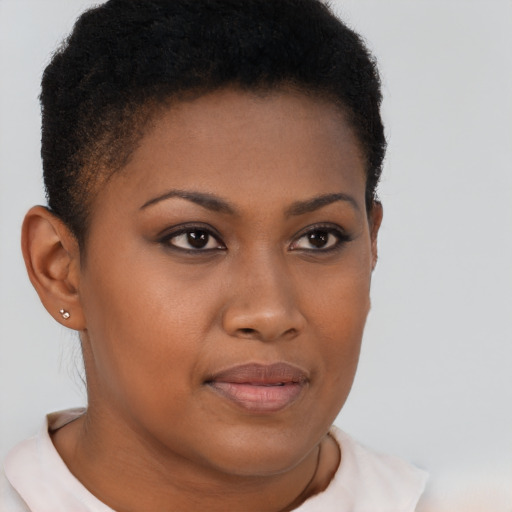 Joyful black young-adult female with short  brown hair and brown eyes