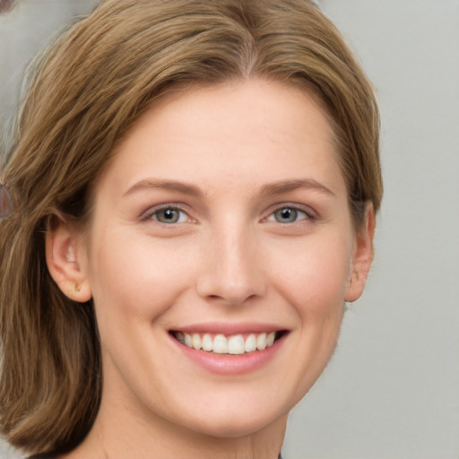 Joyful white young-adult female with long  brown hair and grey eyes