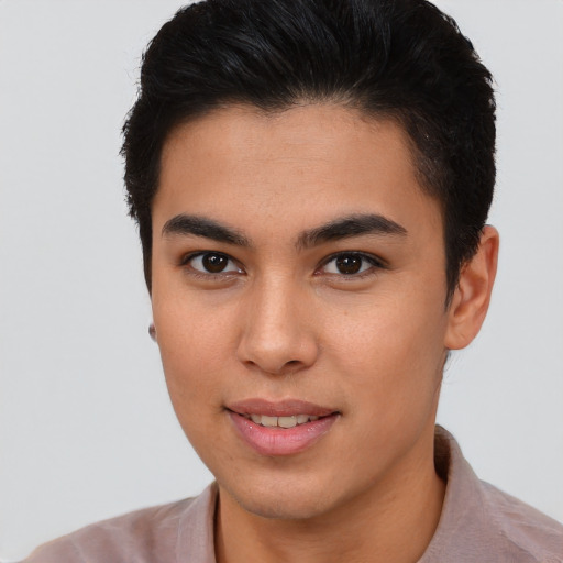 Joyful latino young-adult male with short  brown hair and brown eyes