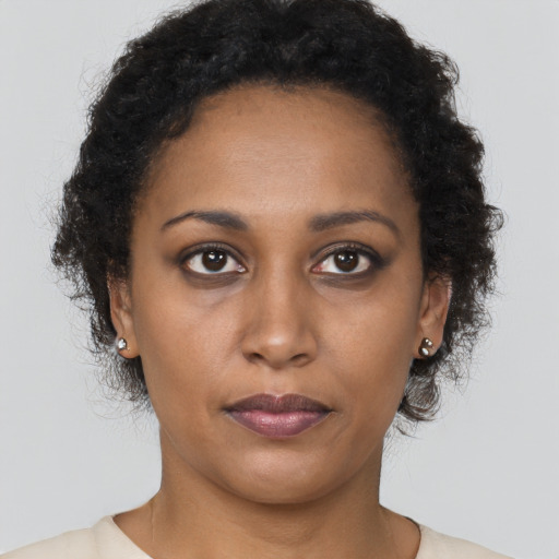 Neutral black young-adult female with long  brown hair and brown eyes
