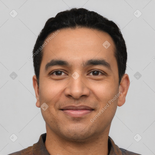 Joyful latino young-adult male with short  black hair and brown eyes