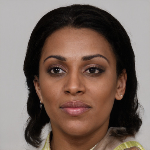 Joyful latino young-adult female with medium  black hair and brown eyes