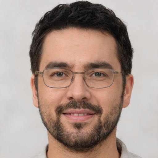 Joyful white adult male with short  brown hair and brown eyes