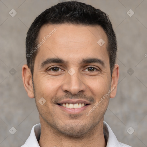 Joyful white young-adult male with short  black hair and brown eyes