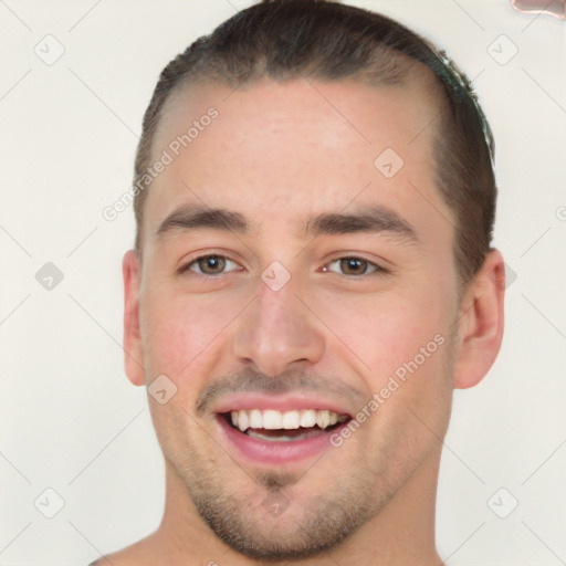 Joyful white young-adult male with short  brown hair and brown eyes