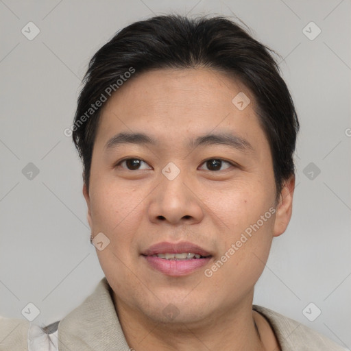 Joyful asian adult male with short  brown hair and brown eyes