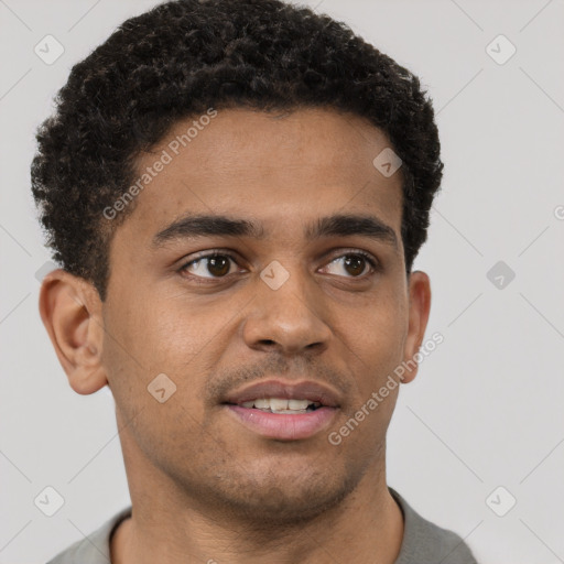 Joyful black young-adult male with short  brown hair and brown eyes