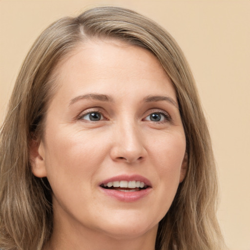 Joyful white young-adult female with long  brown hair and green eyes