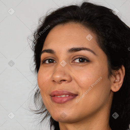 Joyful latino young-adult female with medium  black hair and brown eyes