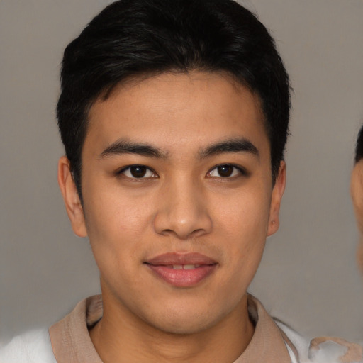 Joyful asian young-adult male with short  brown hair and brown eyes