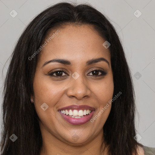 Joyful black young-adult female with long  brown hair and brown eyes