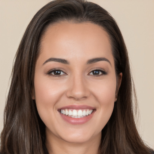 Joyful white young-adult female with long  brown hair and brown eyes