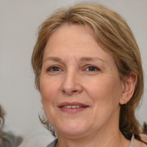 Joyful white adult female with medium  brown hair and grey eyes